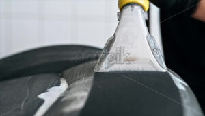 Slow motion chemical cleaning of a car seat at a specialised service with vacuum mop foam - Starpik Stock