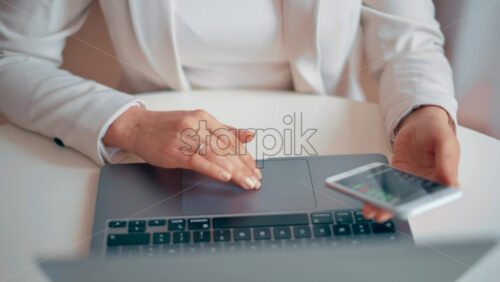 Video - Woman working on notebook and mobile phone