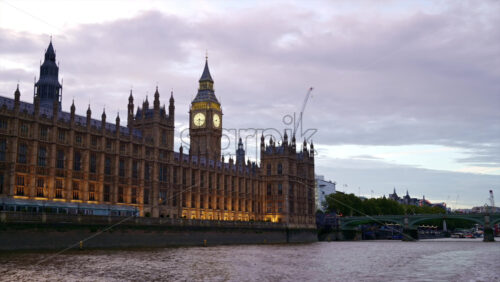 Video - View of London from a floating boat on the Thames River at sunset, United Kingdom. Westminster Palace and Elizabeth Tower