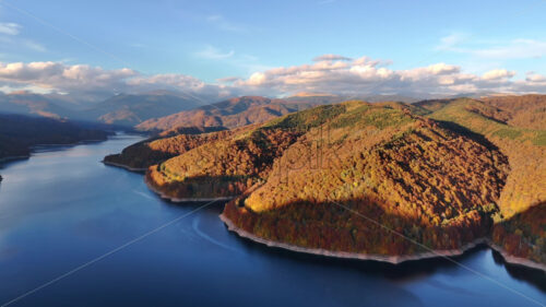 Aerial drone view of Vidraru Lake and Fagaras Mountains. Transfagarasan, Romania. Late autumn season - Starpik