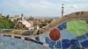 Barcelona, Spain – 27 October, 2023: Park Guell. Antoni Gaudi architecture with walking people and cityscape on the background - Starpik