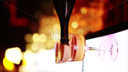 Barman making cocktails with white sparkling wine at the bar at night with red neon lights, slow motion vertical screen - Starpik