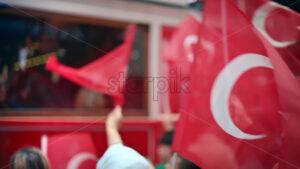 Multiple people waving turkish flags in city downtown at the Commemoration of Ataturk, Youth and Sport, slow motion - Starpik
