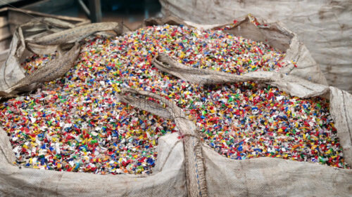 Sack of sorted multicoloured plastic garbage at waste recycling factory - Starpik