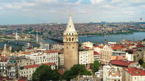 Video – Aerial drone view of Istanbul, Turkey. Multiple residential buildings around the Galata tower, Golden Horn waterway on the background - Starpik Stock
