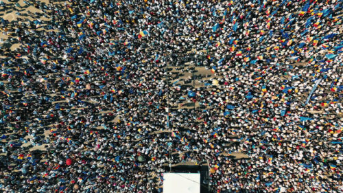 Video – Aerial drone view of the rally in support of the country’s European integration in Chisinau, Moldova. Thousands of people in the city downtown, greenery, EU and national flags - Starpik Stock