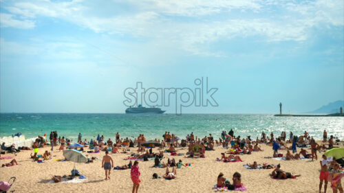 Video – Cannes, France – 26 September, 2023: View of the sea coast with multiple resting people at the beach - Starpik Stock