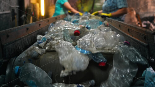 Video – Worker in special wear sorting plastic garbage on a conveyor belt at waste recycling factory - Starpik Stock