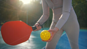 Woman serving the ball in pickleball game. Outdoor court on background. Outdoor court. Slow motion - Starpik