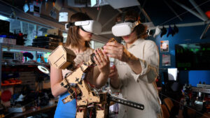 Young man and woman in VR glasses doing experiments in robotics in a laboratory. Robot on the table. Slow motion - Starpik