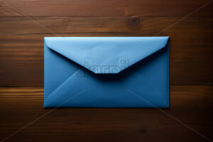 A blue envelope on a dark wooden surface - Starpik Stock