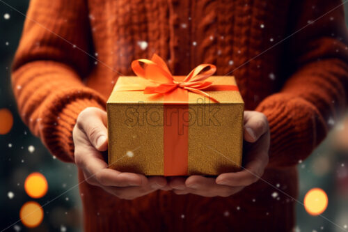 A man holding a giftbox wearing a warm sweater winters holidays - Starpik