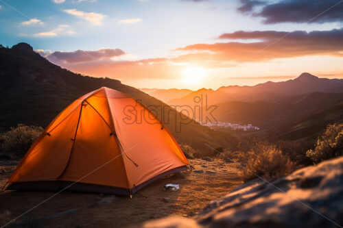 A tent on a hilltop in the background an extraordinary view - Starpik Stock