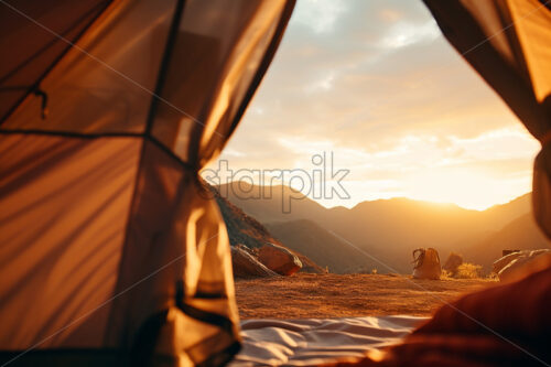 A tent on a hilltop in the background an extraordinary view - Starpik Stock