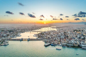 Aerial drone view of Istanbul at sunset, Turkey. Multiple residential buildings, mosques, Galata and Metro bridges over the Golden Horn waterway with floating ships - Starpik Stock
