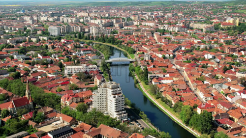 Aerial drone view of Oradea downtown, Romania. Cityscape with multiple historical buildings made in classic style, Crisul Repede river, greenery - Starpik Stock