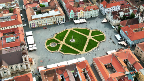 Aerial drone view of Timisoara, Romania. View of the city downtown, Unirii Square with people and multiple historical buildings around - Starpik Stock