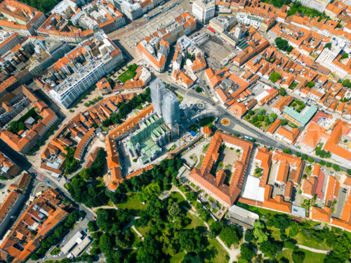 Aerial drone view of Zagreb, Croatia. Historical city centre with multiple old buildings made in national style, Zagreb Cathedral, greenery - Starpik Stock