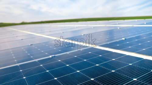 Aerial drone view of blue solar panels installed on a high efficient energy factory roof - Starpik Stock