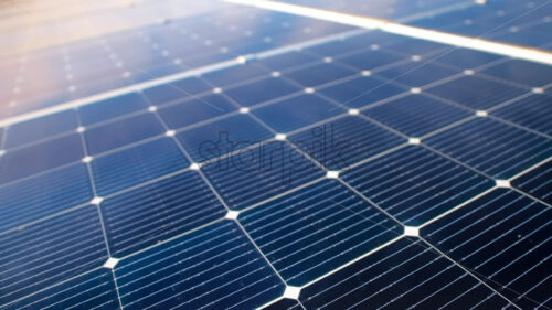 Aerial drone view of blue solar panels installed on a high efficient energy factory roof - Starpik Stock