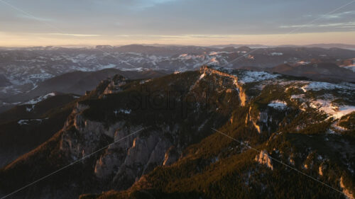 Aerial drone view of sunrise in the mountains. Ceahlau National Park, Romania - Starpik Stock