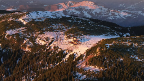 Aerial drone view of sunrise in the mountains. Ceahlau National Park, Romania - Starpik Stock