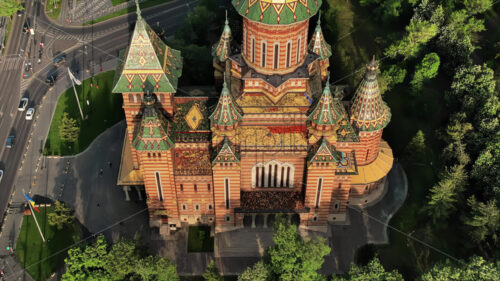 Aerial drone view of the Orthodox Cathedral facade with historical buildings and greenery around in Timisoara, Romania - Starpik Stock