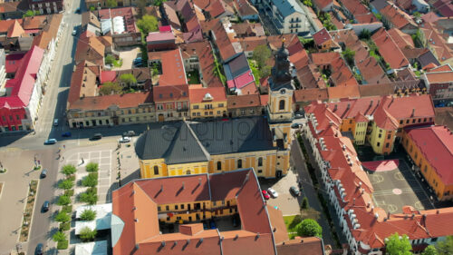 Areal drone view of the Cathedral of St. Nicholas in Oradea downtown, Romania. Unirii Square and historical buildings around - Starpik Stock