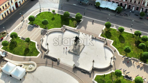 Areal drone view of the Unirii Square in Oradea downtown, Romania. King Ferdinand I statue and walking people around - Starpik Stock