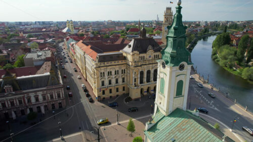 Areal drone view of the Unirii Square in Oradea downtown, Romania. Saint Ladislaus Church and Town Hall, walking people - Starpik Stock