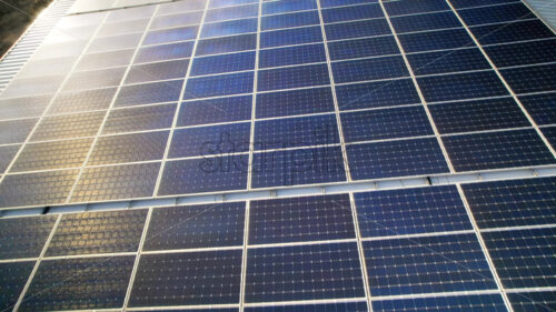 Big solar panels on roof at a factory - Starpik Stock