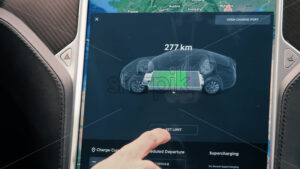 CHISINAU, MOLDOVA – JANUARY, 2022: Tesla Model S P90 interior. Driver using display, charging and consumption information - Starpik Stock