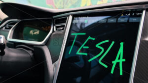 CHISINAU, MOLDOVA – JANUARY, 2022: Tesla Model S P90 interior. Driver writing text on the display - Starpik Stock