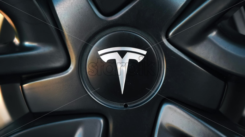 Video - CHISINAU, MOLDOVA - MAY, 2023: Front view of a moving black Tesla Model 3 on a highway. Nature on the background. Slow motion