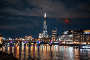 Cityscape of London at evening, United Kingdom. Thames river with bridges, multiple buildings and The Shard skyscraper - Starpik Stock