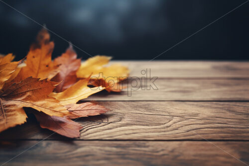 Dry yellow leaves on a wooden table - Starpik Stock