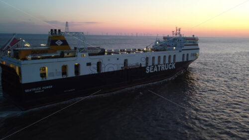 LIVERPOOL, UNITED KINGDOM – MAY 10 2023: Aerial drone vew of Seatruck cargo boat near port at sunset - Starpik Stock