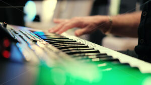 Musician artist man playing colored piano music wedding party, close up bokeh lights - Starpik Stock