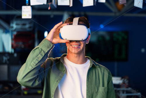 Portrait of a young smiling man in VR glasses - Starpik Stock