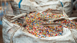 Sack of sorted multicoloured shredded plastic garbage at waste recycling factory - Starpik Stock