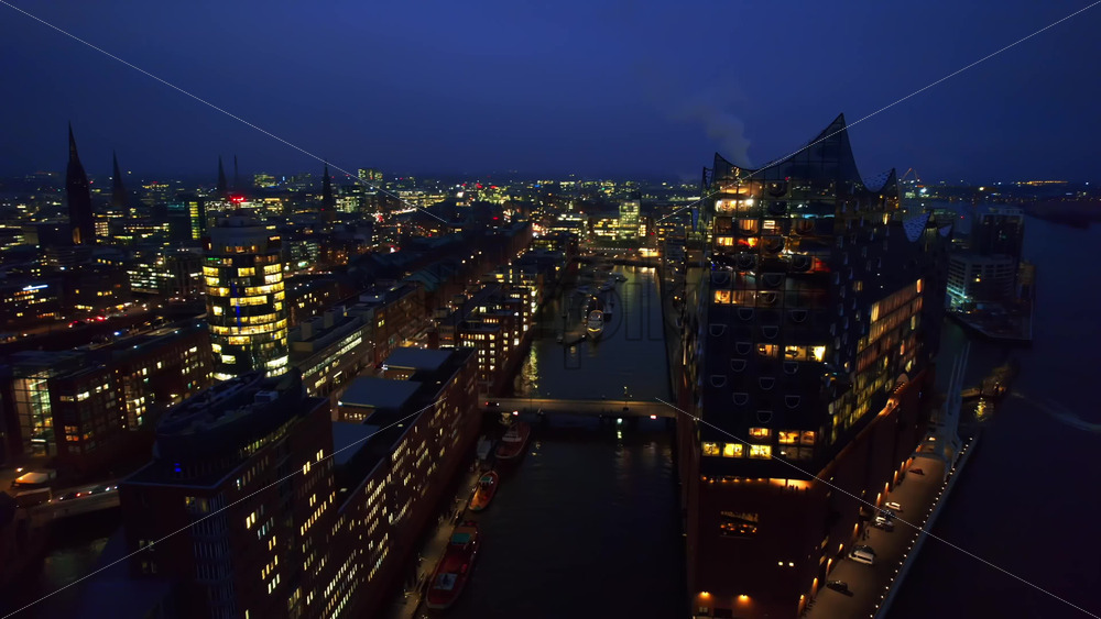 Video - Aerial drone cinematic view of Hamburg city and port with harbour at night, Germany