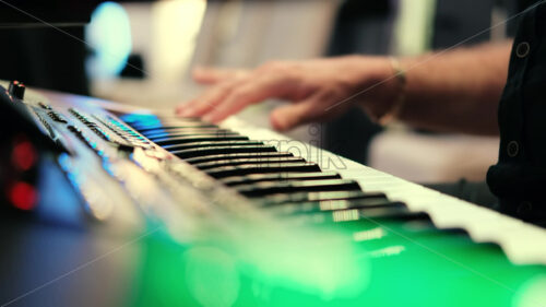 Video – Musician artist man playing colored piano music wedding party, close up bokeh lights - Starpik Stock