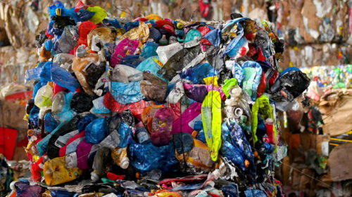 Video – Plastic bottles trash heaps at a sorting plant, slow motion drone view - Starpik Stock