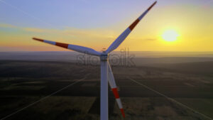 Windturbine energy electricity generator at sunset - Starpik Stock