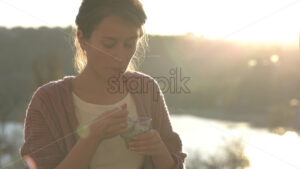 Woman eating chia pudding at sunset slow motion video - Starpik Stock