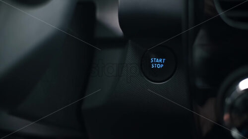 Woman presses the engine start button in the car. Slow motion - Starpik