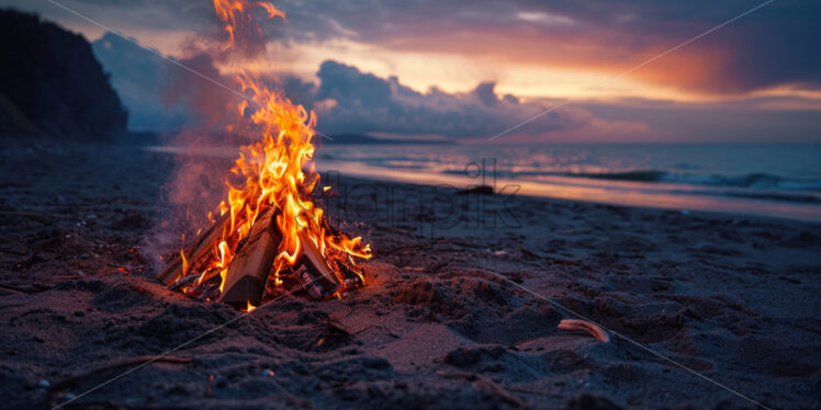 A beachside bonfire with the soothing sound of crackling flames - Starpik Stock