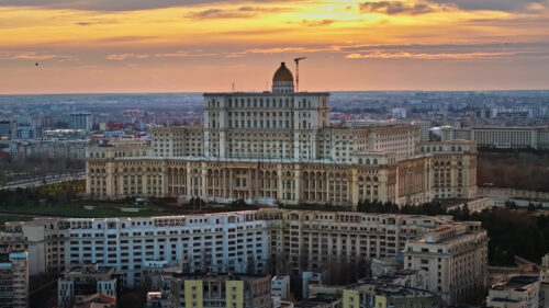 Aerial drone view of Palace of the Parliament in Bucharest downtown at sunset. Multiple districts around, Romania - Starpik Stock