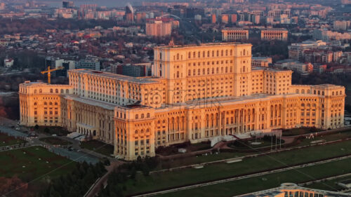 Aerial drone view of Palace of the Parliament in Bucharest downtown at sunset. Romania - Starpik Stock
