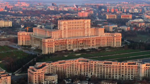 Aerial drone view of Palace of the Parliament in Bucharest downtown at sunset. Romania - Starpik Stock